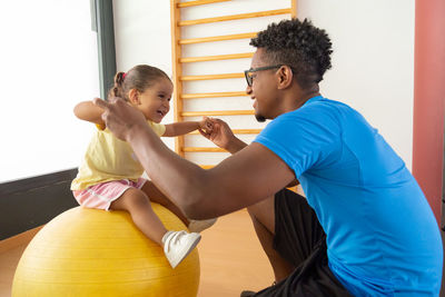 Side view of woman exercising in gym