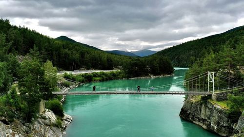 Scenic view of lake by mountains against sky