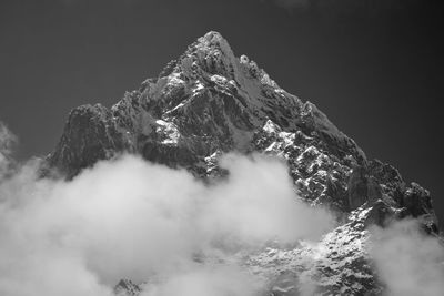 Low angle view of snowcapped mountain against sky