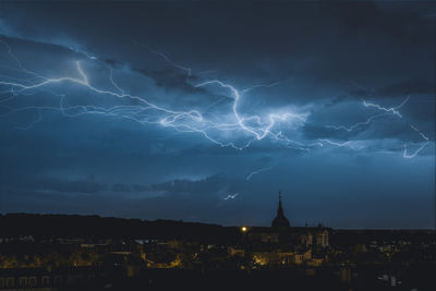 Panoramic view of illuminated city against sky at night