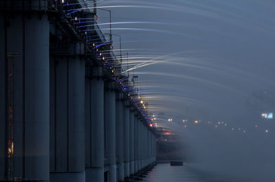 Illuminated fountain on banpo bridge over han river at dusk