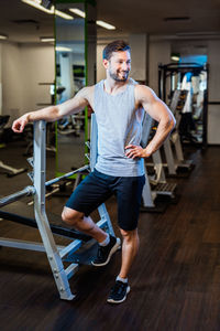 Portrait of young woman exercising in gym