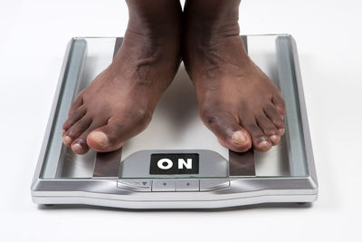 Midsection of man using smart phone on table