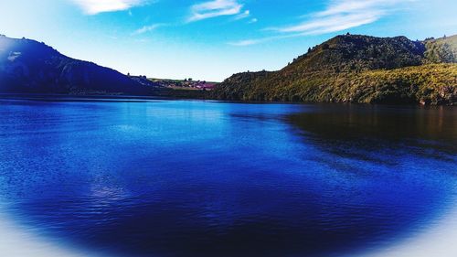 Scenic view of lake against blue sky