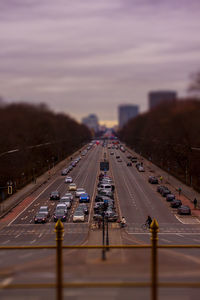 Tilt-shift image of cars on two lane highway at sunset