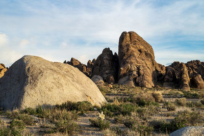 Rock formations on landscape against sky