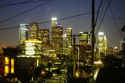 Illuminated cityscape against sky at night