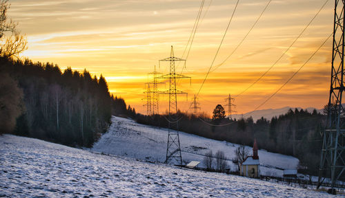 Scenic view of snow covered landscape against sky during sunset