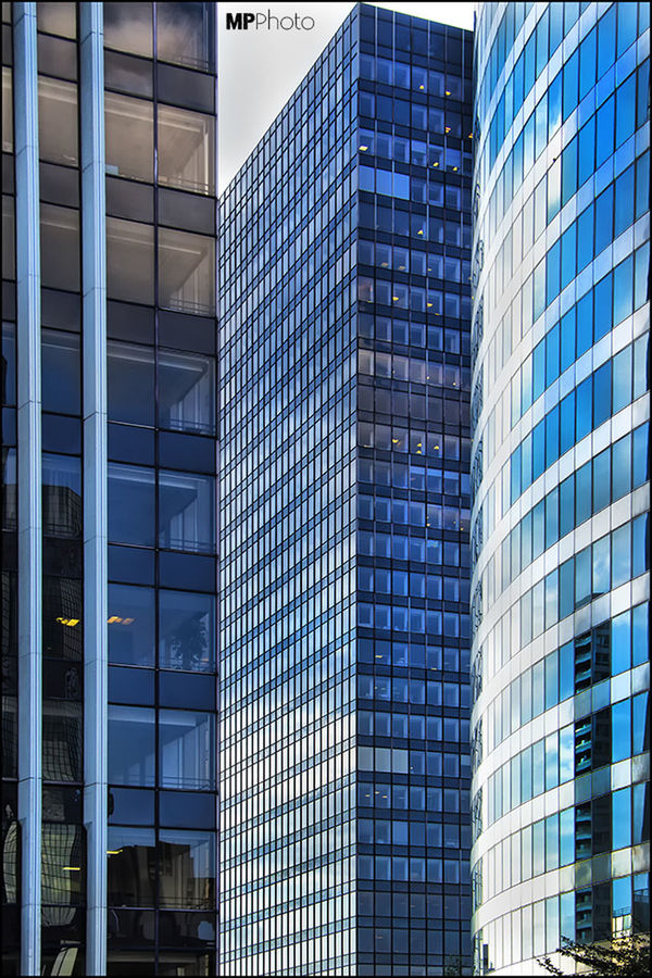 architecture, building exterior, built structure, modern, city, office building, window, glass - material, building, skyscraper, reflection, low angle view, full frame, tall - high, city life, day, backgrounds, no people, tower, outdoors