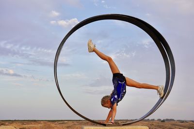 View of girl in gymnastic move in a circle