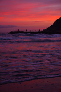 Scenic view of sea against romantic sky at sunset