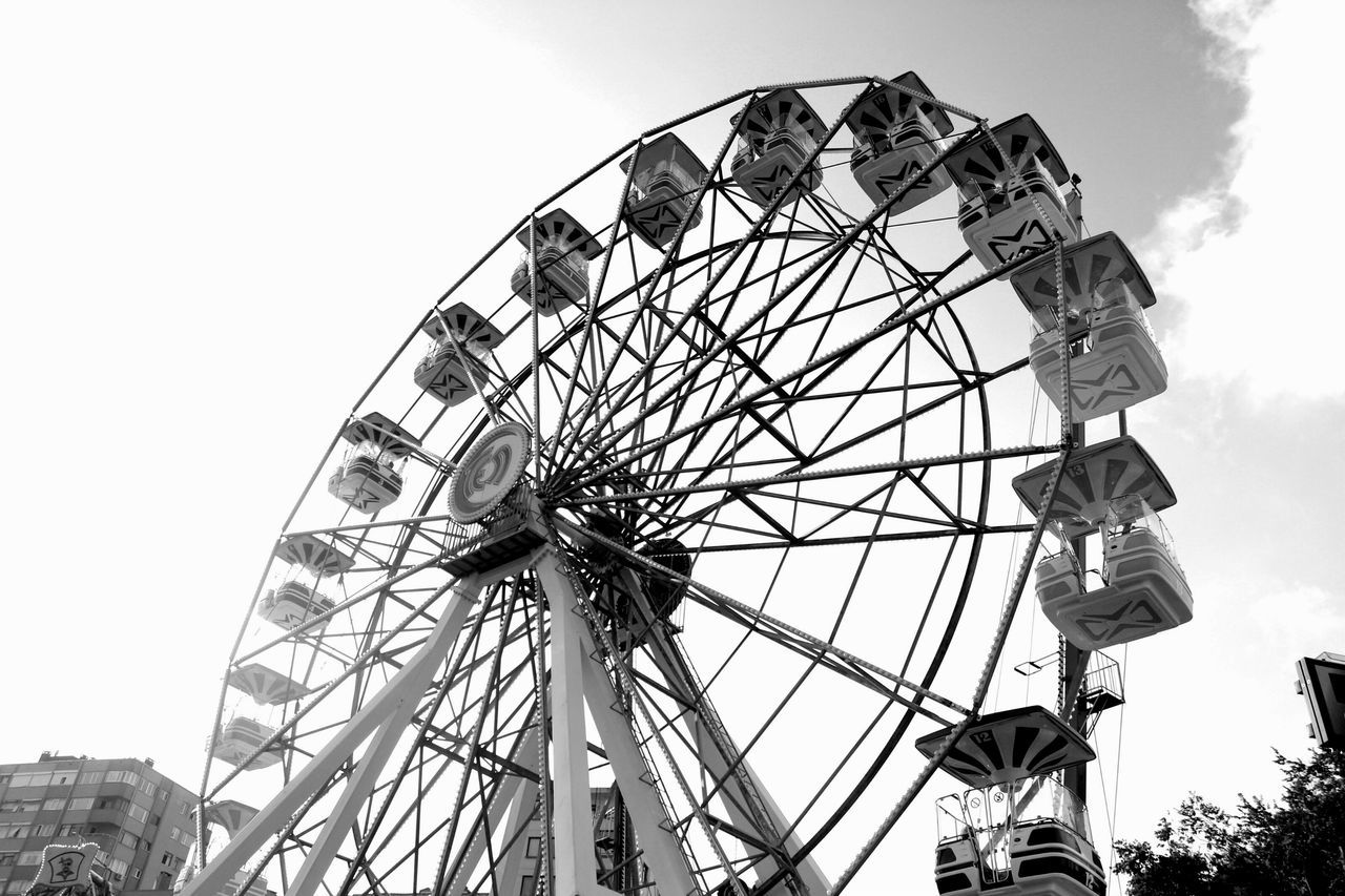 ferris wheel, amusement park ride, amusement park, low angle view, arts culture and entertainment, built structure, sky, clear sky, architecture, metal, large, fun, travel destinations, day, enjoyment, rollercoaster, tourism, outdoors, big wheel, fairground ride