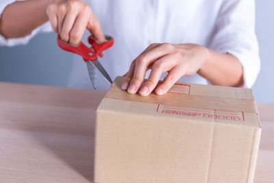 Midsection of man working on wooden table