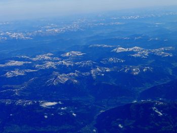 Aerial view of city against blue sky