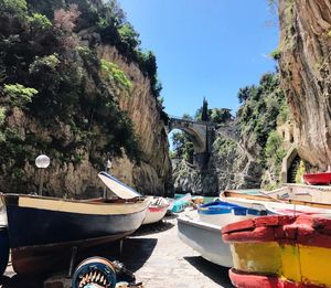 Boats moored on land against sky