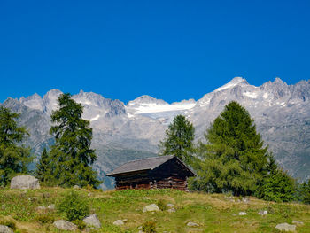 Built structure on mountain against clear blue sky