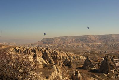 Hot air balloons flying over landscape at cappadocia