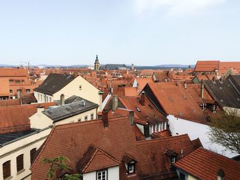 High angle view of red tile rooftops in town