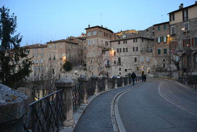 Street amidst buildings against sky