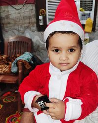 Portrait of cute boy holding camera