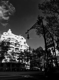 Low angle view of trees and buildings against sky