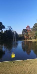 Scenic view of lake against clear blue sky
