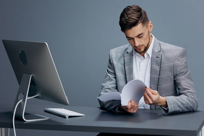 Businessman reading document in office