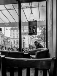 People sitting in restaurant seen through glass window