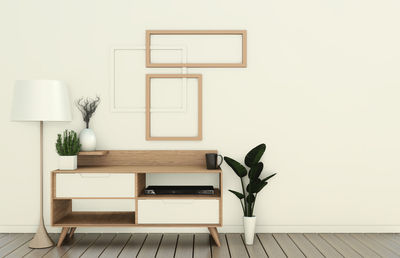 Potted plant on table against wall at home