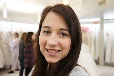 Close-up portrait of smiling young woman in store