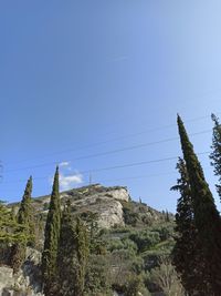 Low angle view of mountain against clear blue sky