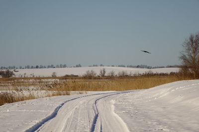 Scenic view of snow field against clear sky