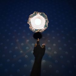 Close-up of hand holding light bulb