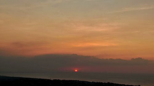 Scenic view of sea against romantic sky at sunset