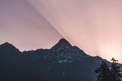 Low angle view of snowcapped mountains against sky during sunset