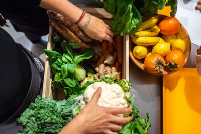 Midsection of woman holding fruits