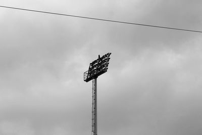 Stadium light with cloudy sky in the background