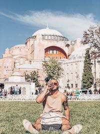 Rear view of man photographing with smart phone