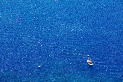 High angle view of sea against clear blue sky