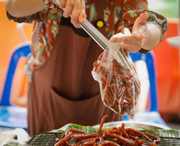 Midsection of woman preparing food