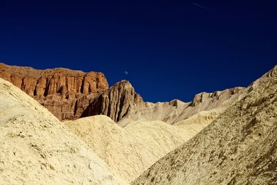 Scenic view of mountains against clear blue sky