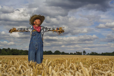 Full length of man standing on field against sky