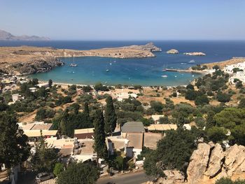 High angle view of townscape by sea against sky