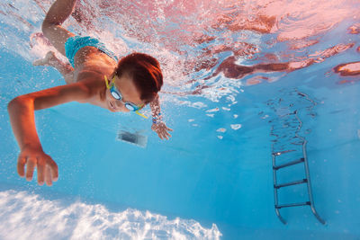 Young woman swimming in pool