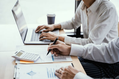 Midsection of woman working on table