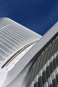 Low angle view of modern building against blue sky