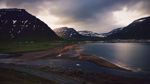 Scenic view of mountains against cloudy sky