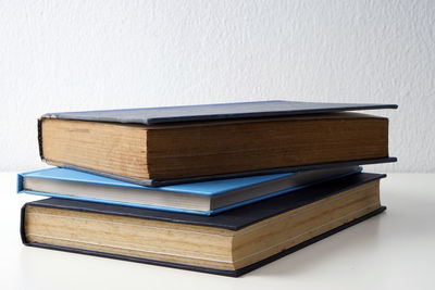 Close-up of stack of books against white background