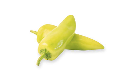 Close-up of green chili pepper against white background