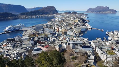 High angle view of townscape by sea against sky